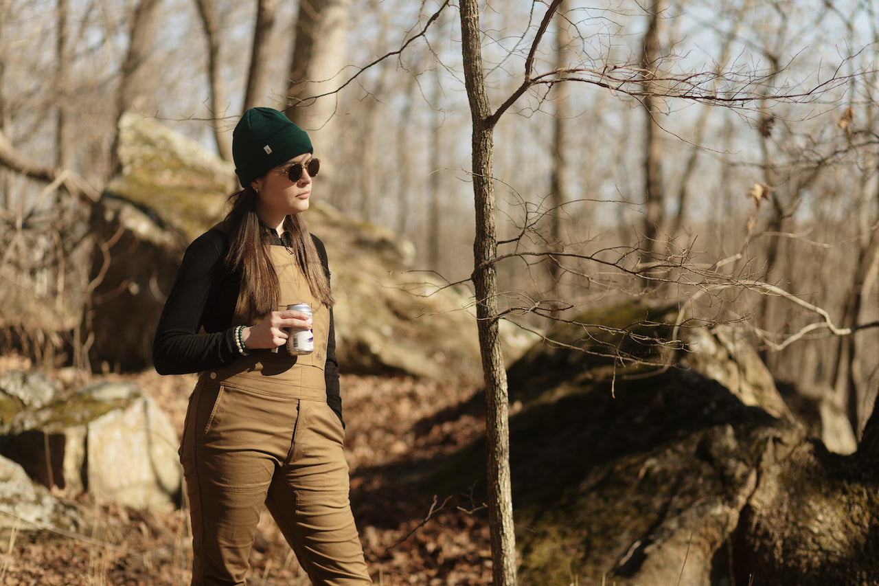 Woman outside in overalls
