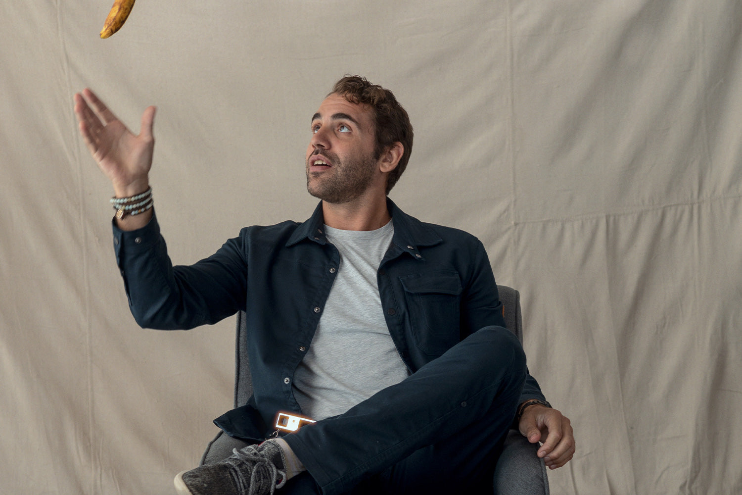 A man is throwing a banana